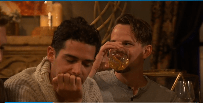 evan sits sugly behind his drink